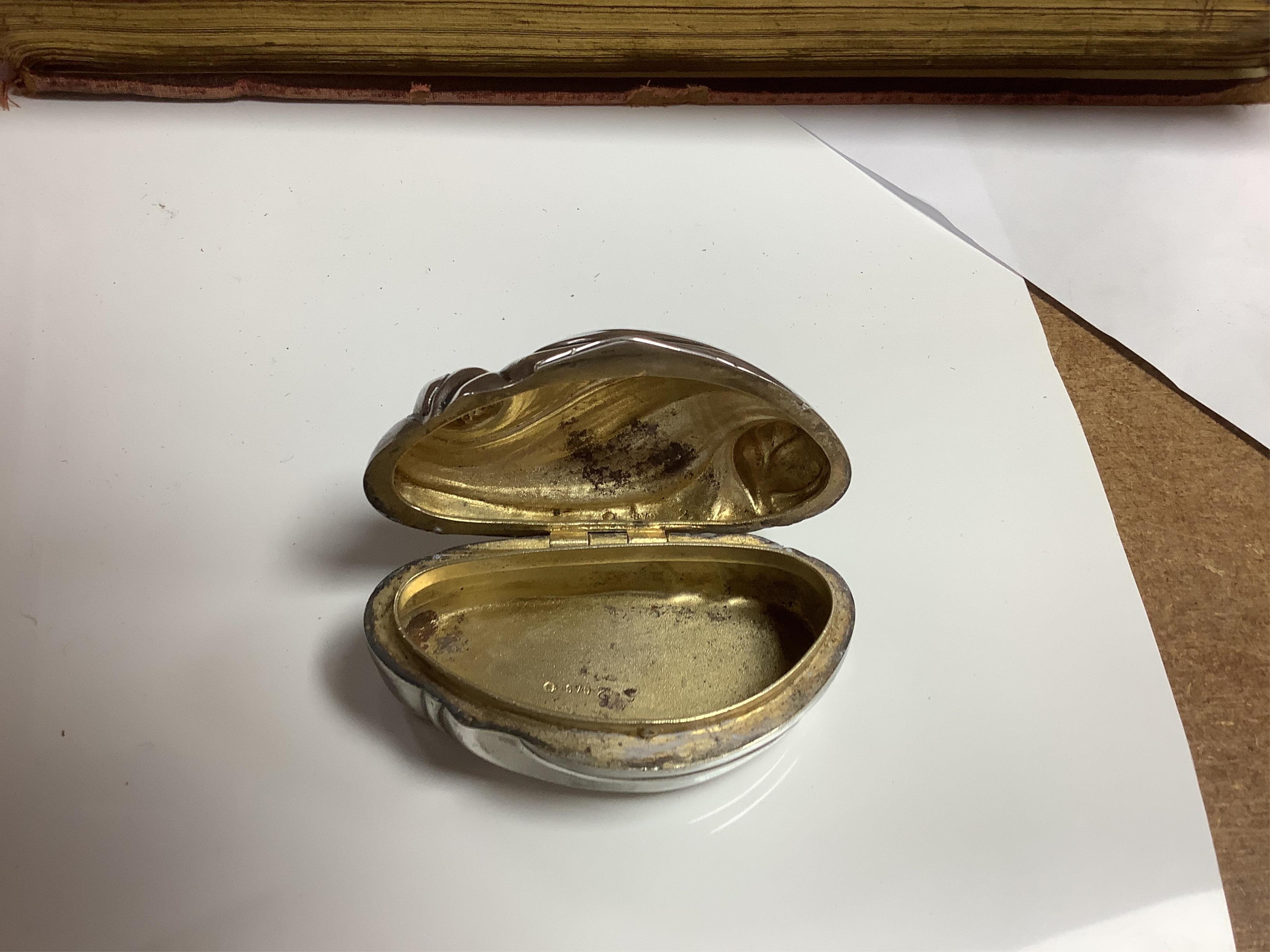 An Elizabeth II silver three piece condiment set, Sheffield, 1964, six assorted silver napkin rings and a stylish Austro Hungarian white metal pill box, by George Adam Scheid, 62mm. Condition - fair